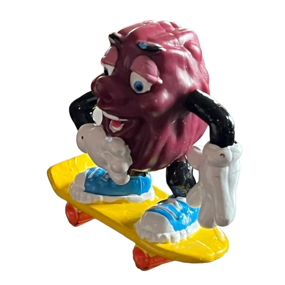 Vintage 1980s California Raisins Figure Riding a Skateboard Cake Topper